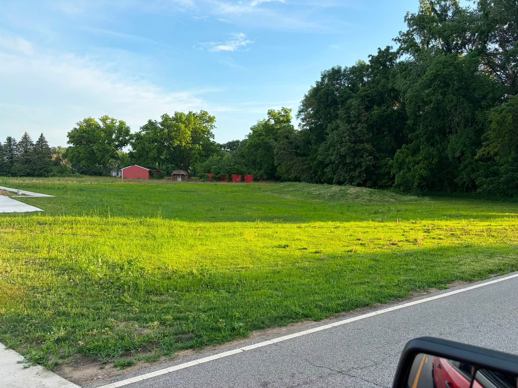 Open field and farm buildings before site work